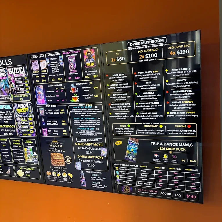 In-store menu boards listing dried mushrooms, edibles and microdose capsules at Funguyz Enfield Pl