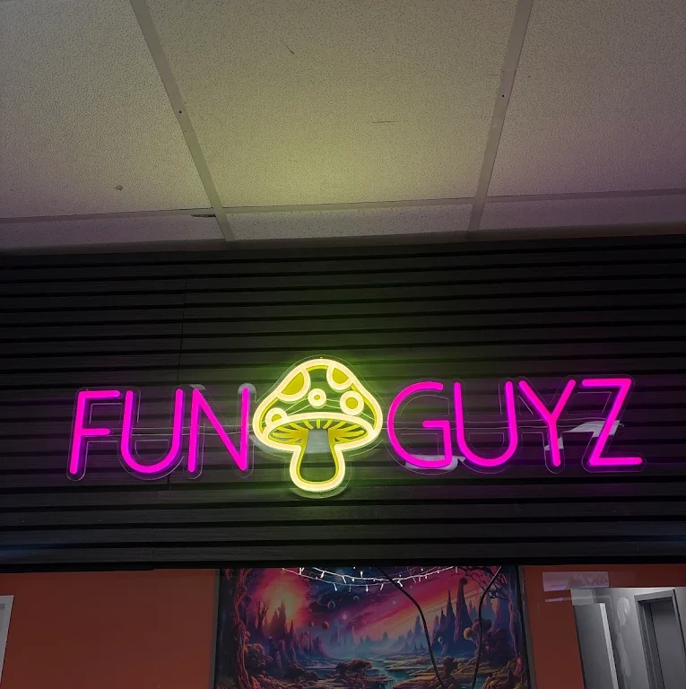 Pink and yellow Funguyz neon mushroom sign inside the Enfield Pl dispensary in Mississauga