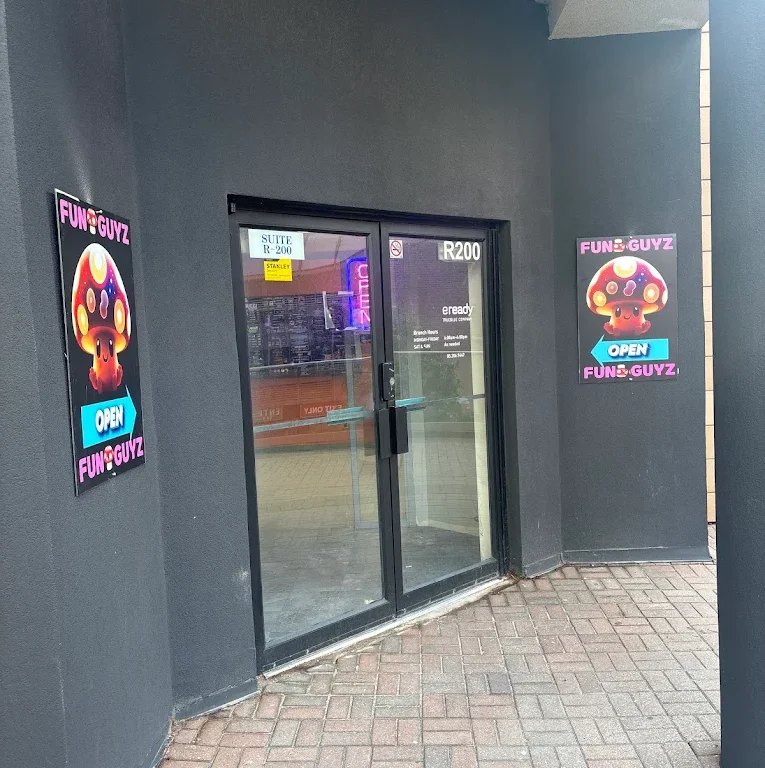 Glass entrance doors of Funguyz unit R200 at 265 Enfield Pl, Mississauga, with Funguyz open signs
