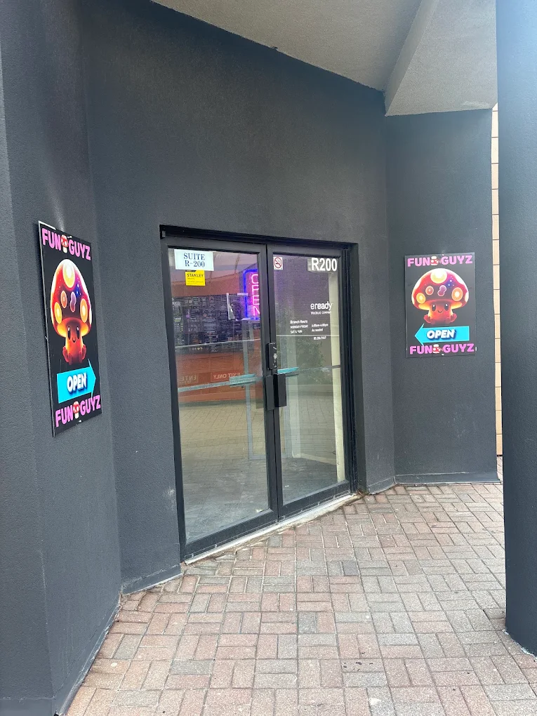 Glass entrance doors of Funguyz unit R200 at 265 Enfield Pl, Mississauga, with Funguyz open signs