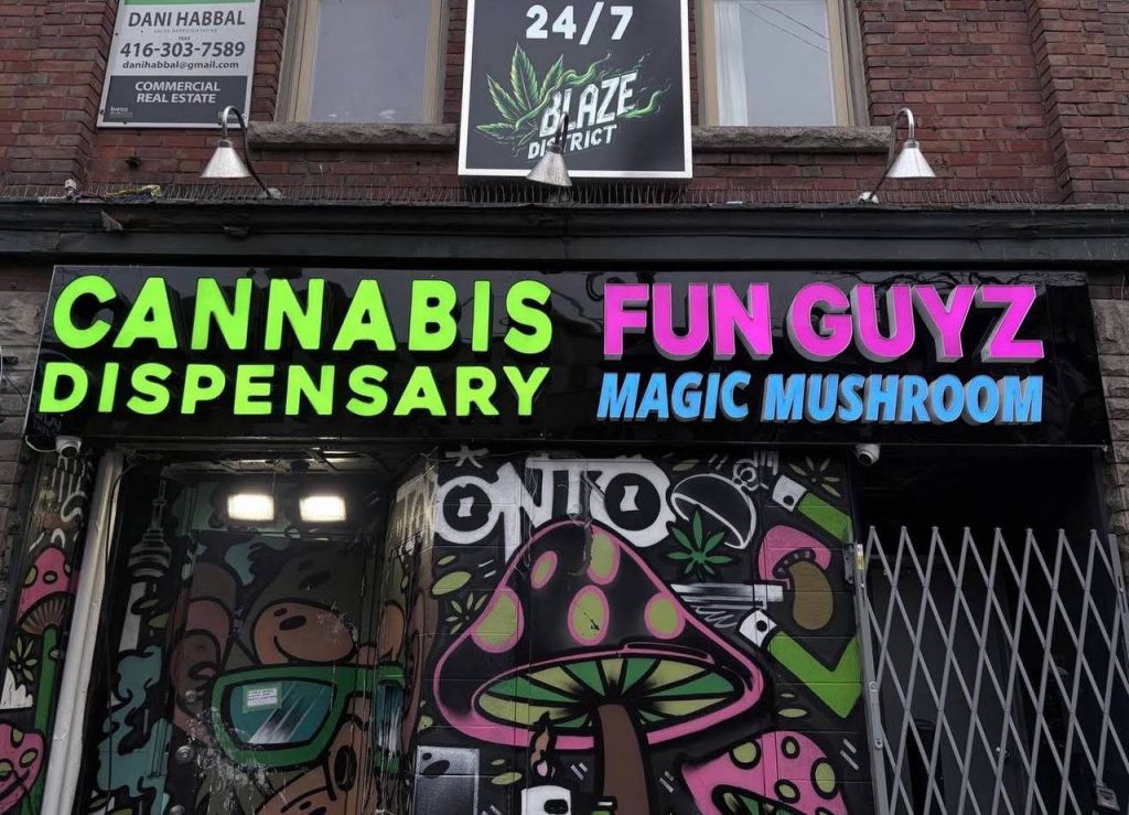FunGuyz magic mushroom dispensary sign at 497 Bloor St West, Toronto, open 24 hours