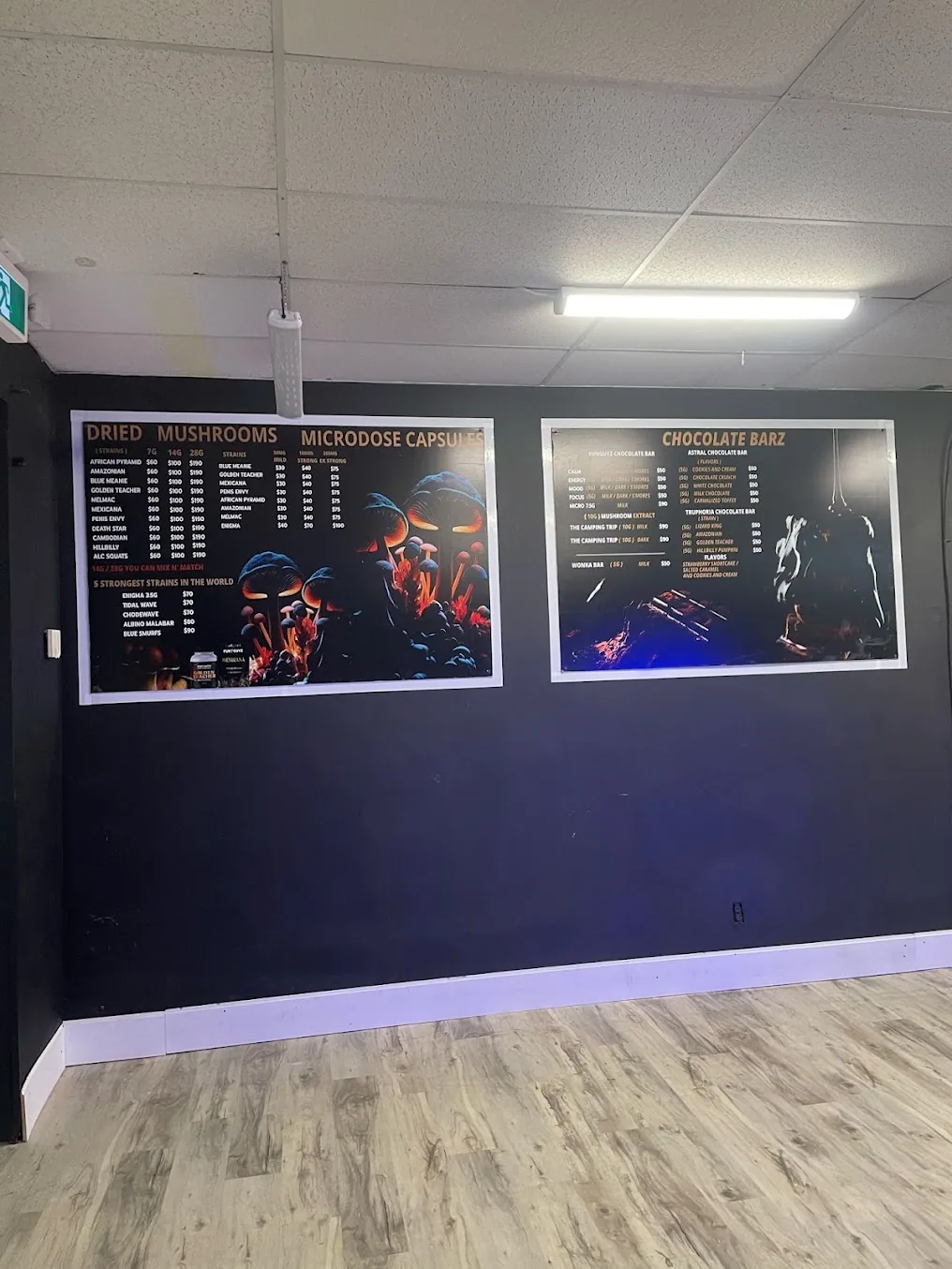 Menu boards for dried mushrooms, microdose capsules and chocolate bars at FunGuyz Niagara Falls